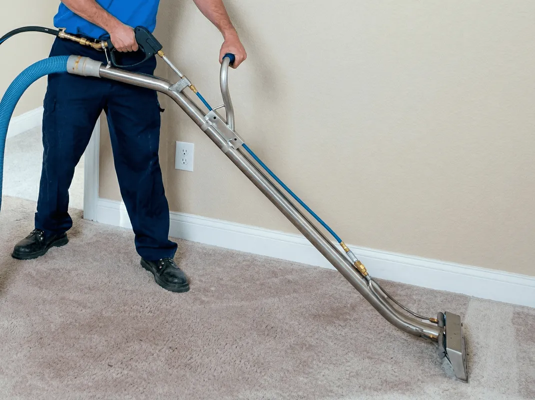 Professional operating a liquid removal machine on a carpeted floor in Lakeland, FL